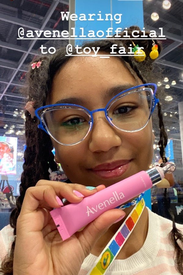 Soco holding her Rose lip balm at an event