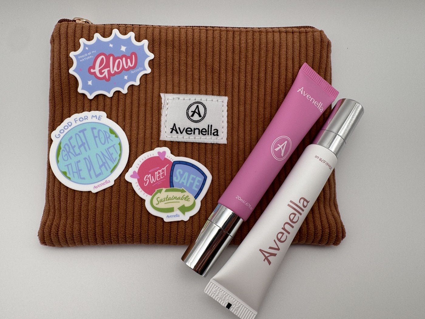 Avenella balms and stickers on a cozy corduroy pouch