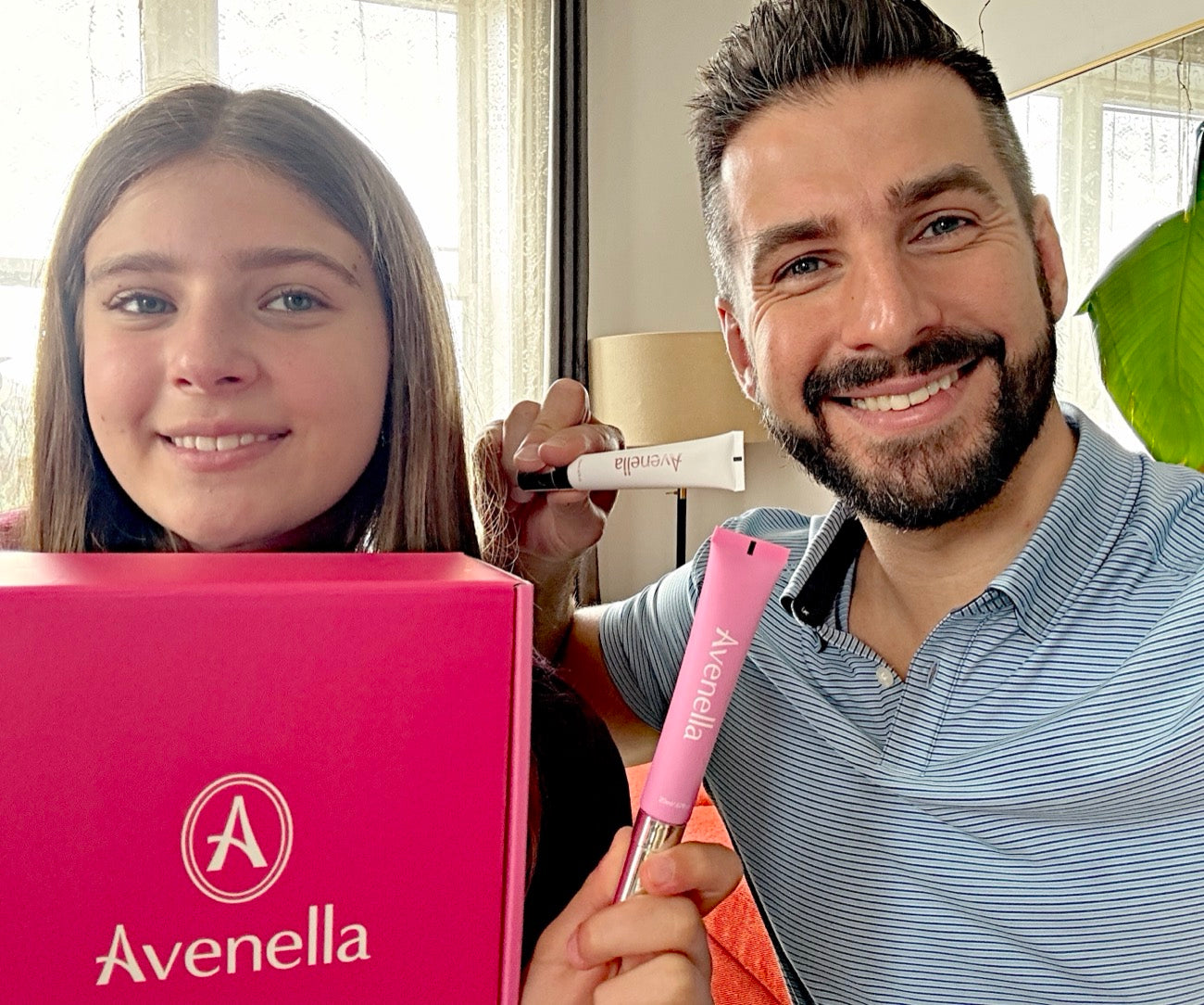 Noa and Vadim smiling with a pink Avenella box and both lip balms