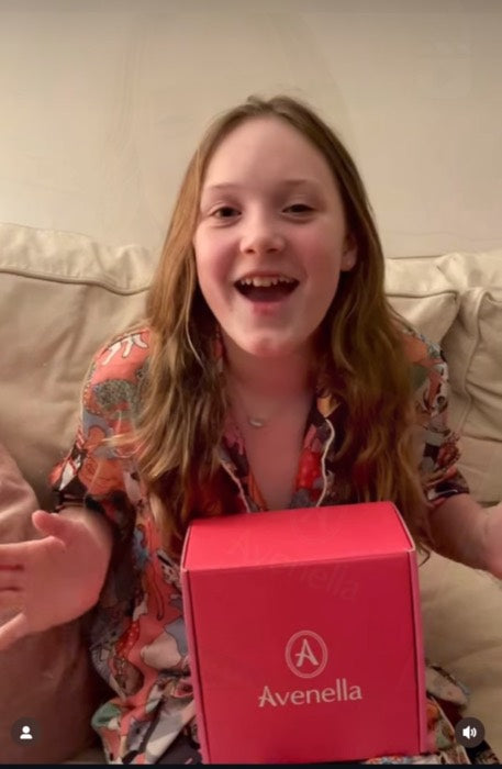 A customer smiling with her Avenella box
