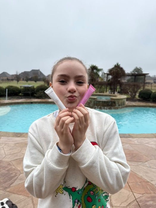 A customer blowing a kiss with her lip balms
