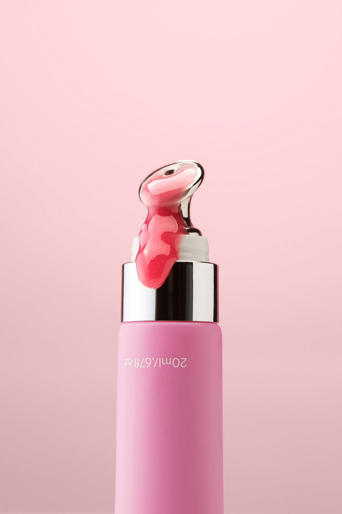 Rose lip balm with its cooling metal applicator, close up