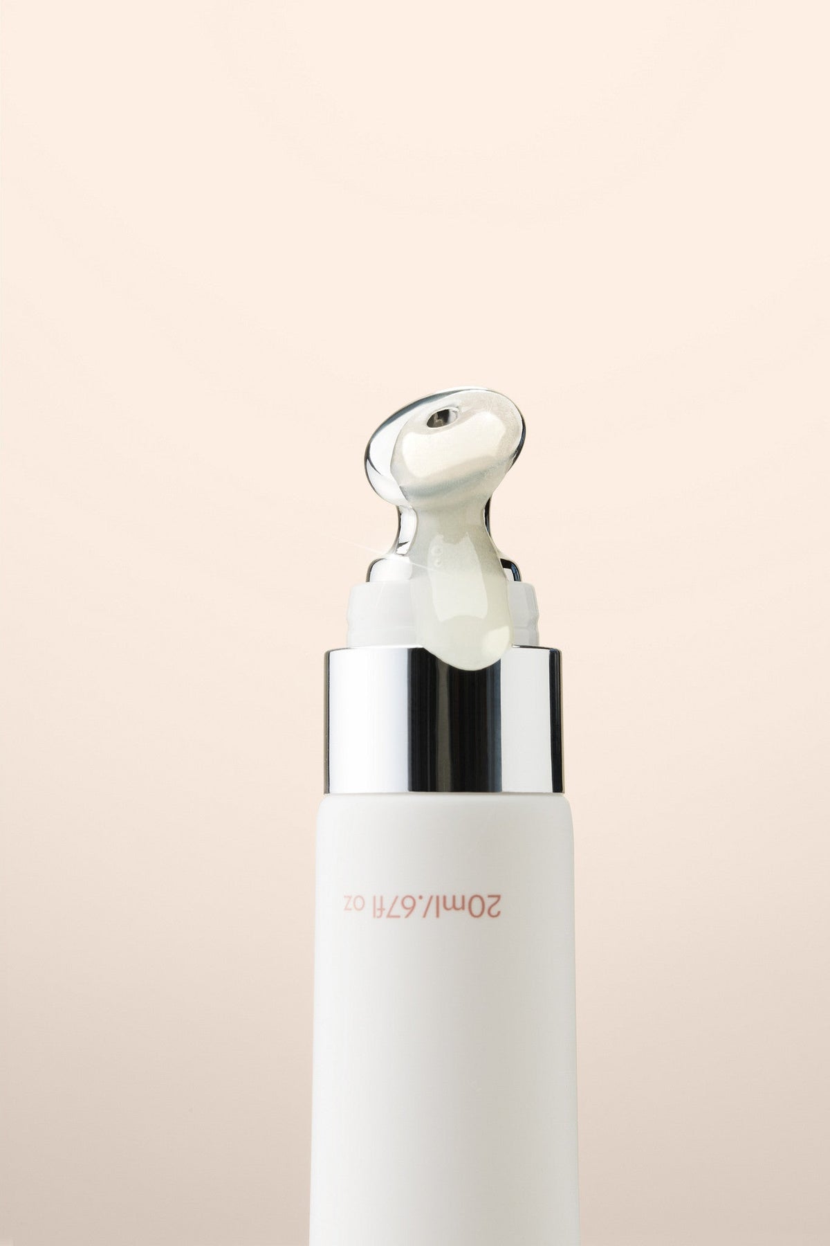 Vanilla lip balm with its cooling metal applicator, close up