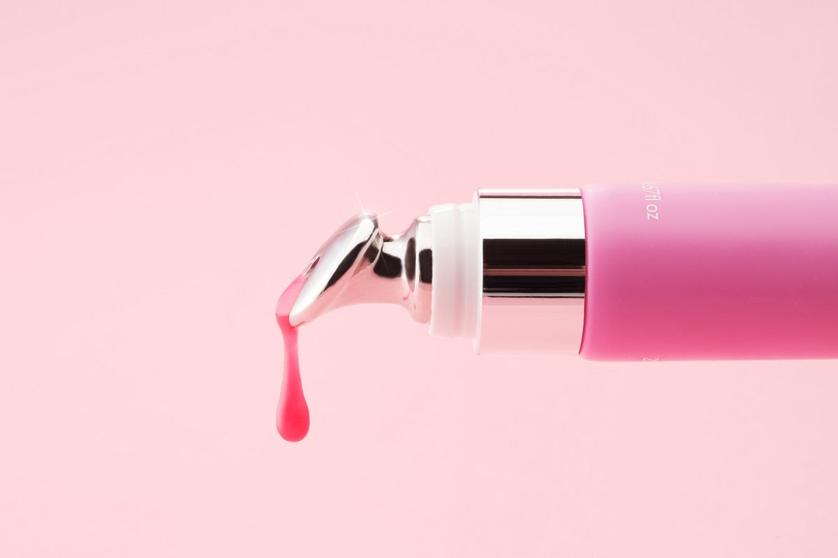 A drop of pink Rose balm on the metal applicator
