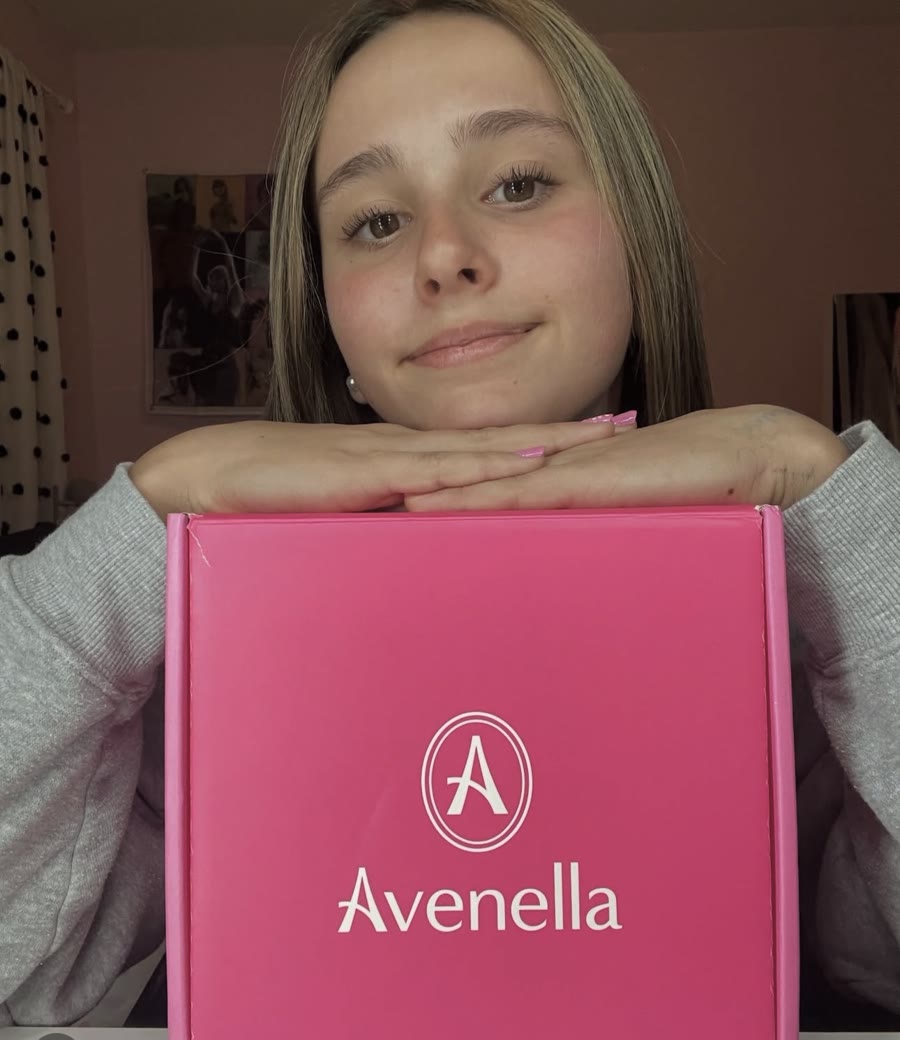 Sabrina resting her chin on her pink Avenella box