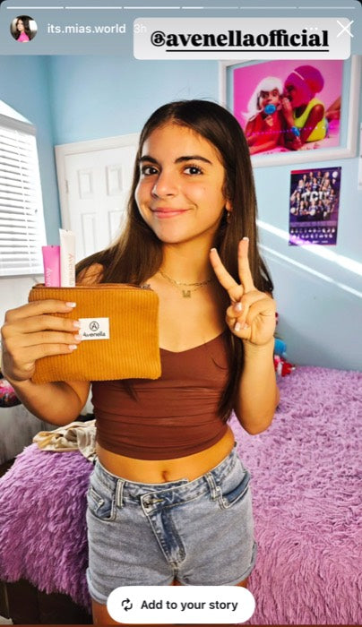 A customer holding her corduroy pouch